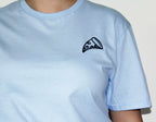 Light blue t-shirt with a black pizza slice embroidery on a plain background