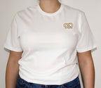 White t-shirt with a pretzel embroidery on a plain background